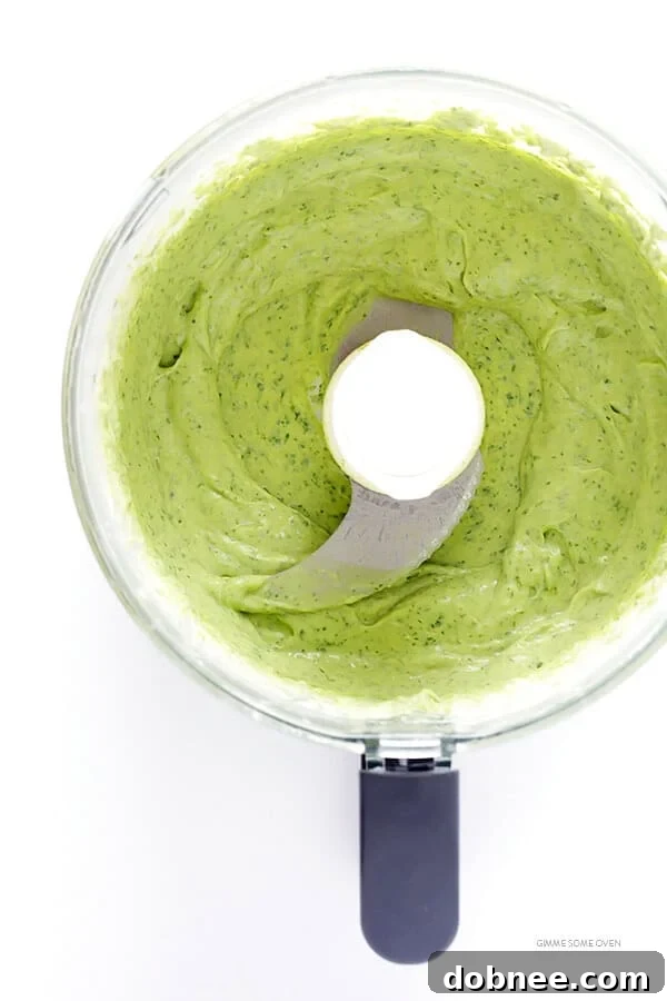 Close-up of the smooth, vibrant green creamy avocado sauce – the perfect complement to savory tacos. | gimmesomeoven.com