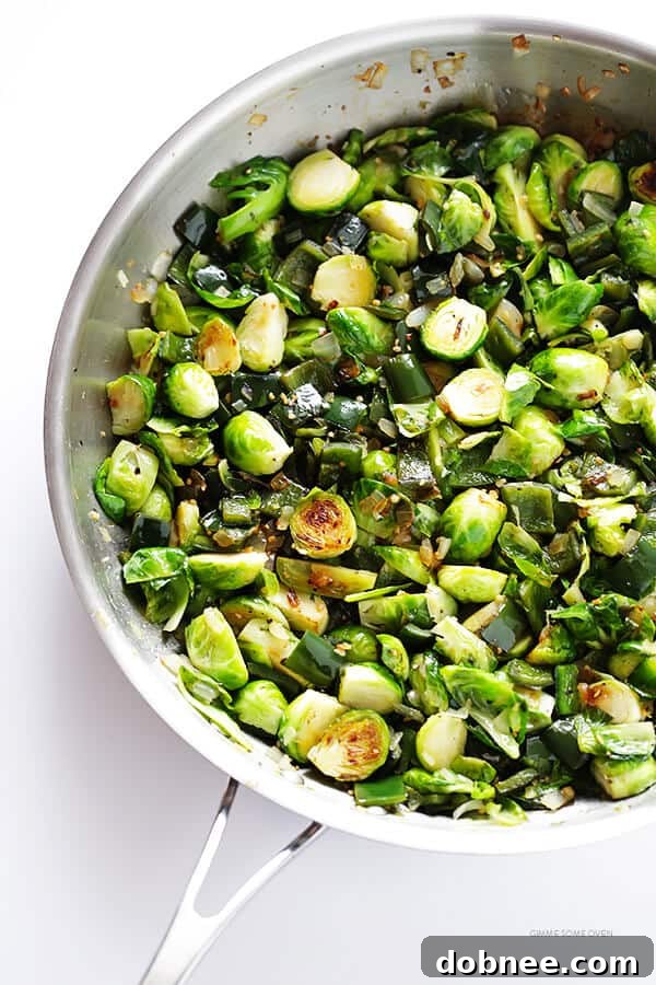 Freshly sautéed Brussels sprouts, poblano peppers, onion, and garlic ready to be combined with black beans for a delicious taco filling. | gimmesomeoven.com