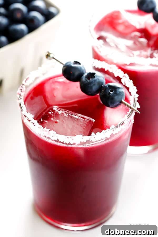 Close-up of a Blueberry Margarita, showcasing its vibrant purple color and fresh blueberry garnish.