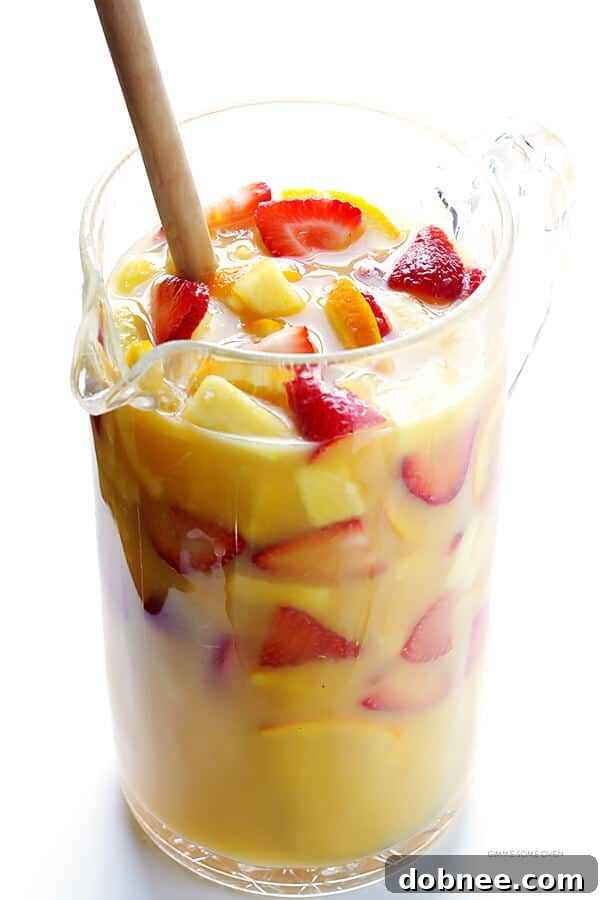 Mimosa Sangria -- quick and easy to make, and kicked up a notch with lots of delicious fresh fruit! | dobnee.com