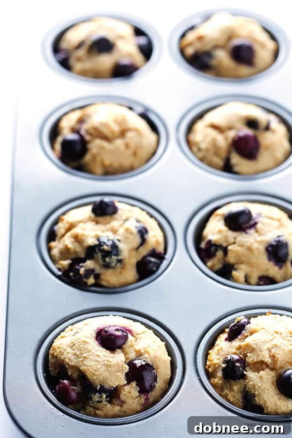 Freshly baked Healthier Blueberry Muffins cooling on a wire rack.