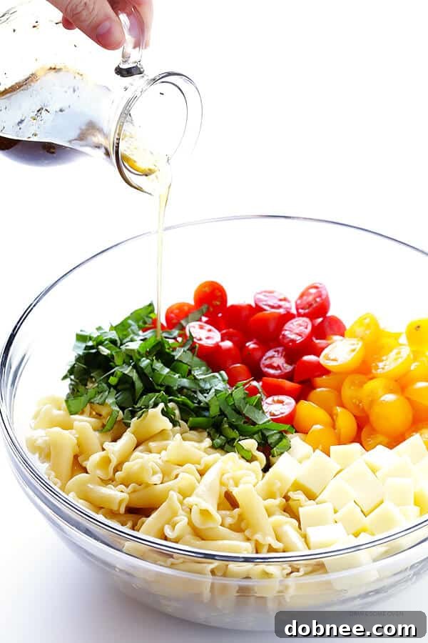 Caprese Pasta Salad in a large mixing bowl, ready to be served, showcasing its fresh and colorful ingredients.