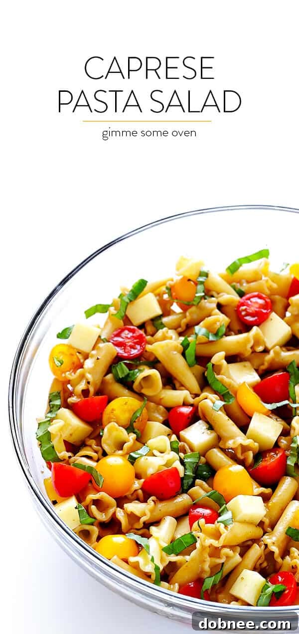 A large serving bowl filled with fresh Caprese Pasta Salad, ready to be enjoyed at a gathering.