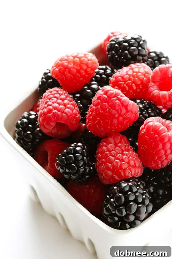 These Berry Cheesecake Popsicles are quick and easy to prep, they're chocked full of fresh berries and graham crackers, and they really do taste like cheesecake! | gimmesomeoven.com