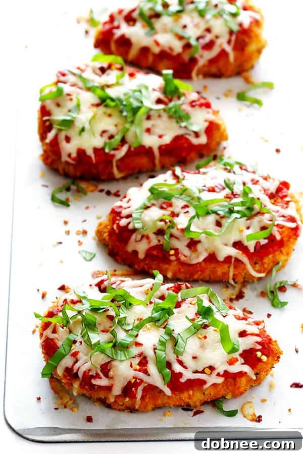 This Spicy Baked Chicken Parmesan recipe is made with a crispy seasoned panko crust, and topped with a spicy marinara sauce, melted mozzarella, and lots of fresh basil. It's surprisingly simple to make, and SO delicious! | gimmesomeoven.com