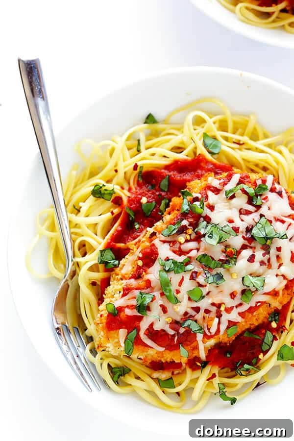 This Spicy Baked Chicken Parmesan recipe is made with a crispy seasoned panko crust, and topped with a spicy marinara sauce, melted mozzarella, and lots of fresh basil. It's surprisingly simple to make, and SO delicious! | gimmesomeoven.com