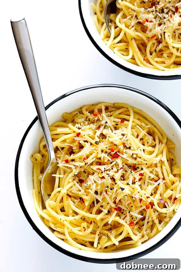 Finished plate of Garlic Lovers' Spaghetti garnished with Parmesan and red pepper flakes.