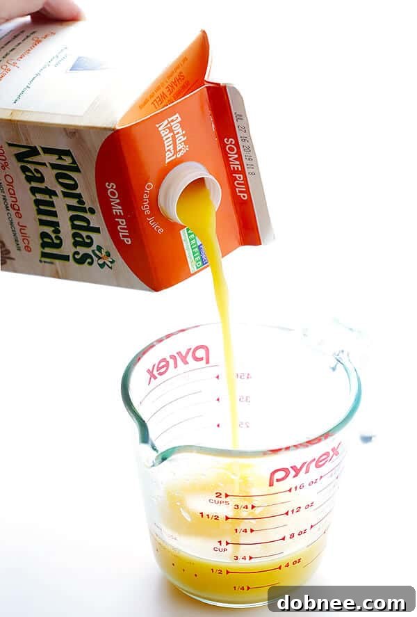 Colorful Orange Chicken Lettuce Wraps served in crisp Bibb lettuce cups, garnished with almonds and green onions. A perfect light meal.