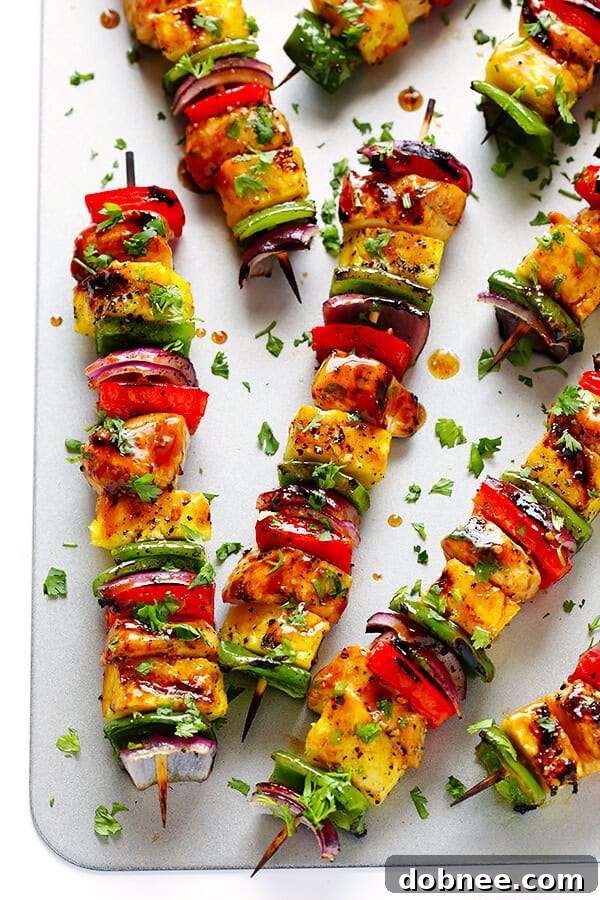 Finished Rainbow Hawaiian Chicken Kabobs, beautifully grilled and garnished with fresh cilantro.