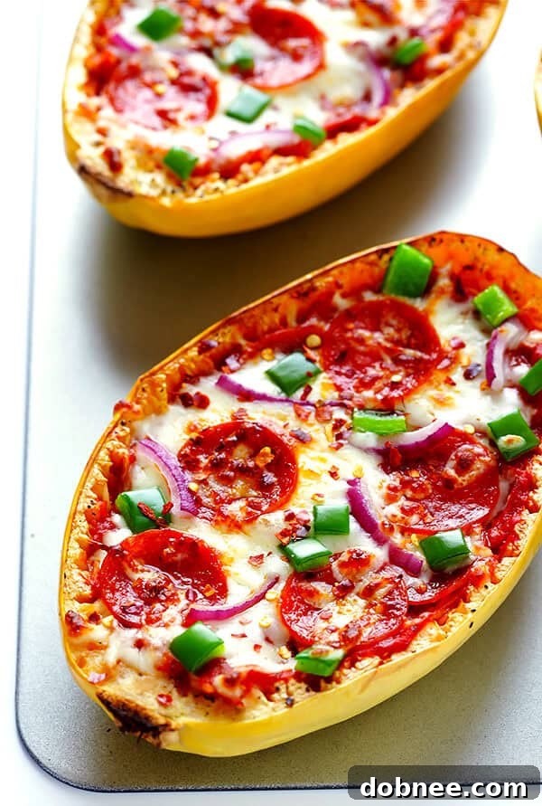 Pizza Night, Squash Style 7 Pizza Spaghetti Squash Boats topped with pepperoni, green peppers, and red onions, ready for broiling