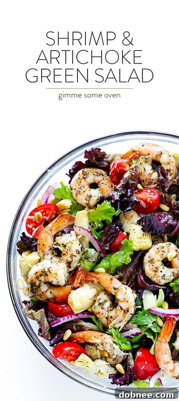 A stunning overhead shot of the complete Shrimp and Artichoke Green Salad, perfectly presented in a large bowl, garnished with extra Parmesan and black pepper. A healthy, flavorful, and beautiful meal, ready to be enjoyed.