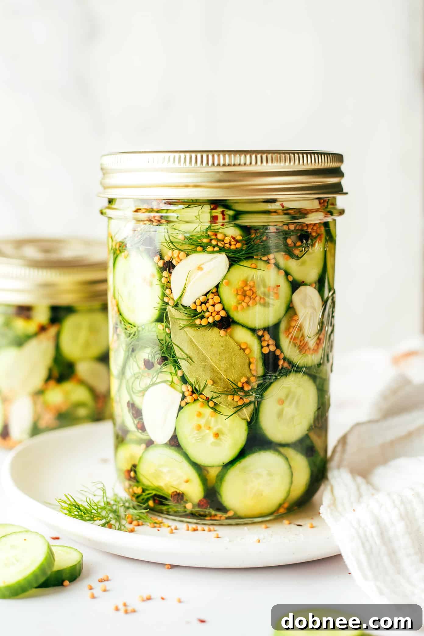 Freshly sliced cucumbers and dill ready for pickling