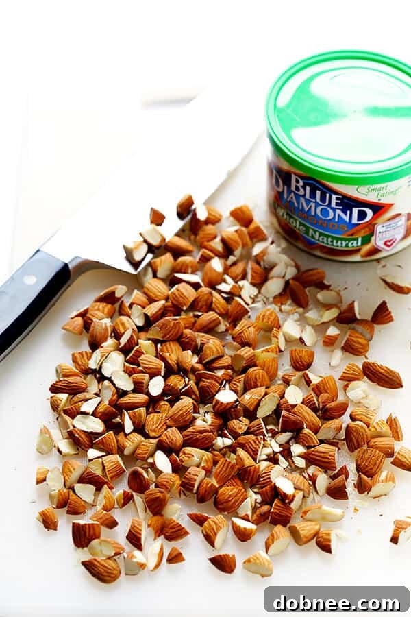 Close-up of Lemon Basil Spaghetti with Almonds, showcasing fresh basil, toasted almond pieces, and vibrant lemon zest tossed with perfectly cooked pasta. | gimmesomeoven.com