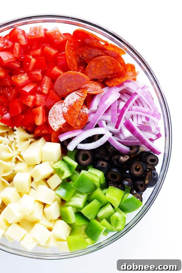 This Pizza Pasta Salad is incredibly easy to customize with your favorite ingredients, making it a versatile and family-friendly recipe for any occasion. Perfect with a simple Italian vinaigrette.