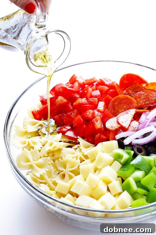 A simple yet flavorful Italian vinaigrette is drizzled over the Pizza Pasta Salad, bringing all the fresh ingredients together in a perfect blend of tangy and herbaceous notes.