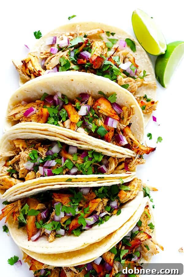 These Slow Cooker Crispy Chicken Carnitas are made easy by simmering for hours in the crock pot, then they're briefly crisped up in the broiler, resulting in tender, crispy, juicy, and absolutely DELICIOUS chicken carnitas. Perfect for tacos, burritos, or whatever sounds good! | gimmesomeoven.com
