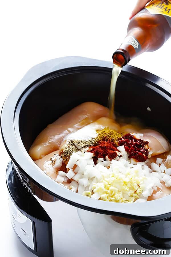 These Slow Cooker Crispy Chicken Carnitas are made easy by simmering for hours in the crock pot, then they're briefly crisped up in the broiler, resulting in tender, crispy, juicy, and absolutely DELICIOUS chicken carnitas. Perfect for tacos, burritos, or whatever sounds good! | gimmesomeoven.com