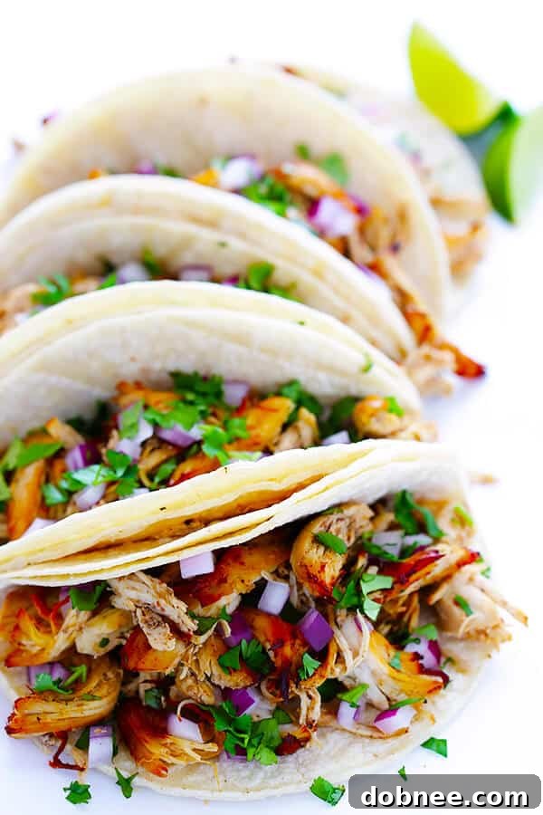 These Slow Cooker Crispy Chicken Carnitas are made easy by simmering for hours in the crock pot, then they're briefly crisped up in the broiler, resulting in tender, crispy, juicy, and absolutely DELICIOUS chicken carnitas. Perfect for tacos, burritos, or whatever sounds good! | gimmesomeoven.com