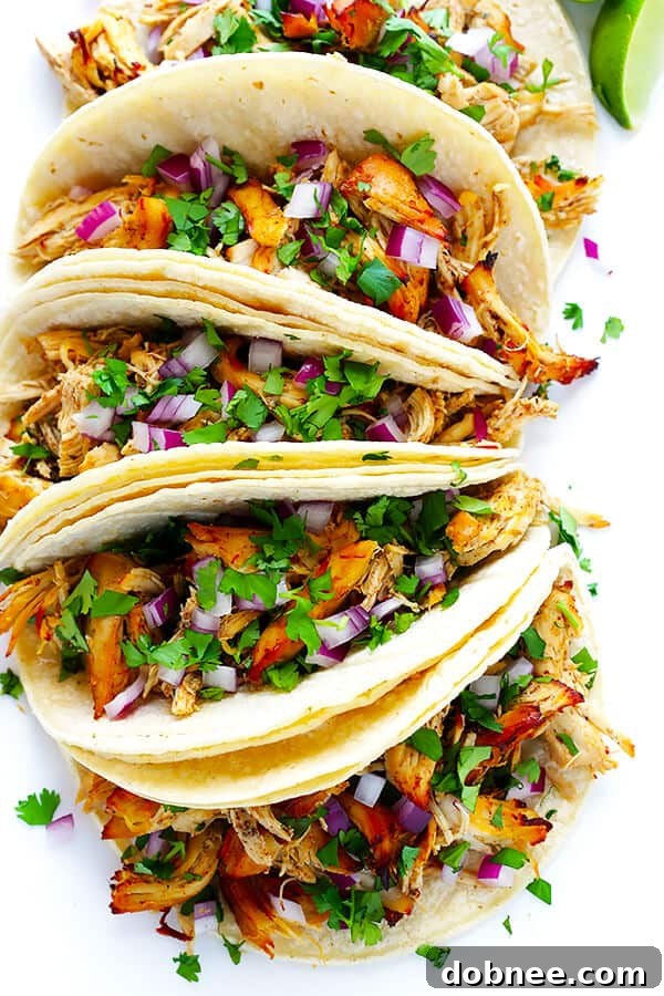These Slow Cooker Crispy Chicken Carnitas are made easy by simmering for hours in the crock pot, then they're briefly crisped up in the broiler, resulting in tender, crispy, juicy, and absolutely DELICIOUS chicken carnitas. Perfect for tacos, burritos, or whatever sounds good! | gimmesomeoven.com