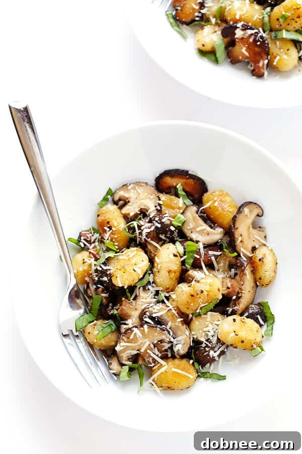 Closeup of freshly toasted gnocchi with sautéed mushrooms in a pan