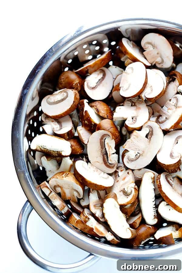 Selection of shiitake and baby bella mushrooms, sliced and ready for cooking