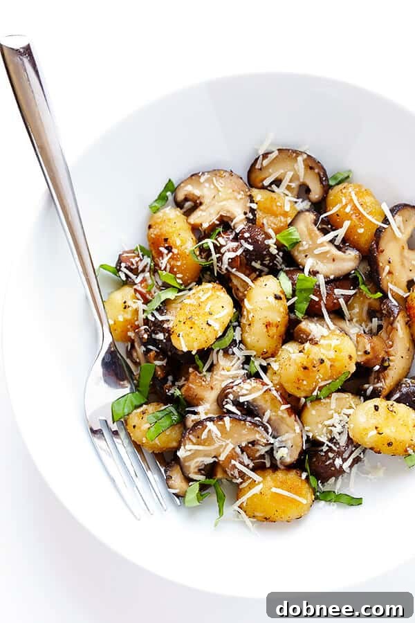 Bowl of Toasted Gnocchi with Mushrooms, Basil, and Parmesan, garnished with extra fresh basil