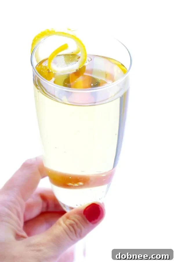 Five French 75 cocktails presented elegantly with lemon twists in a vibrant setting.