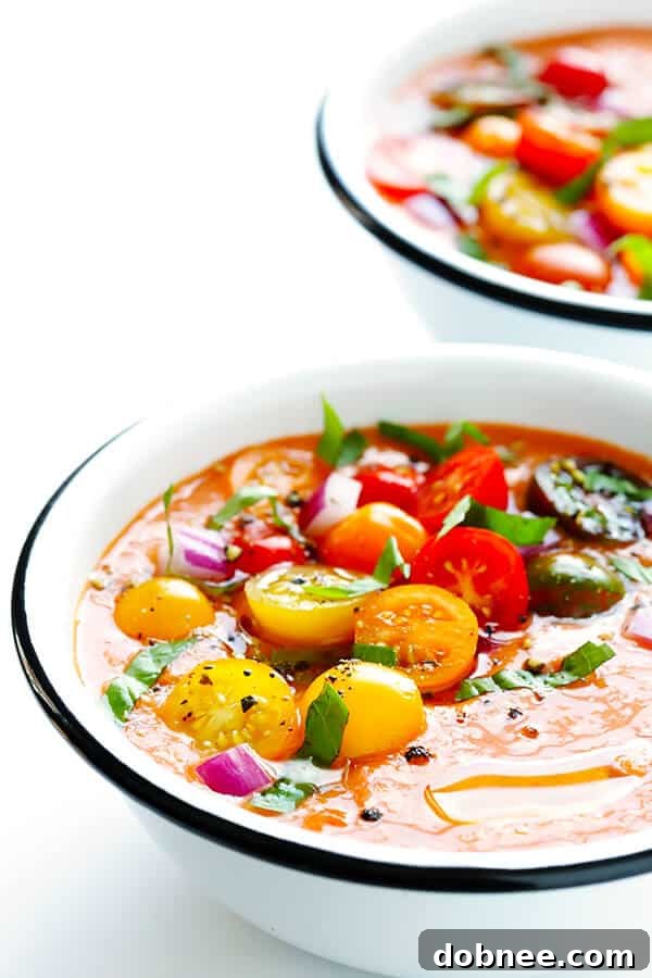 This 10-Minute Gazpacho Recipe is easy to customize with whatever veggies you have on hand, it's easy to make ahead of time, and it's absolutely delicious! Create a vibrant, chilled tomato soup in minutes. | gimmesomeoven.com (Vegetarian / Gluten-Free)