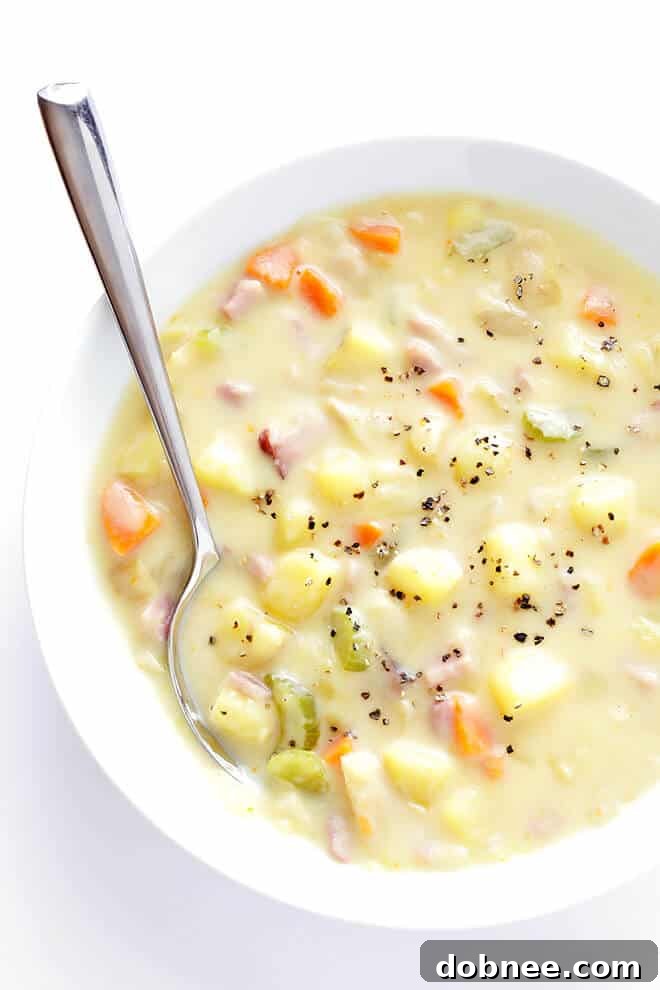 Cooking the creamy ham and potato soup in a large stockpot, simmering gently.