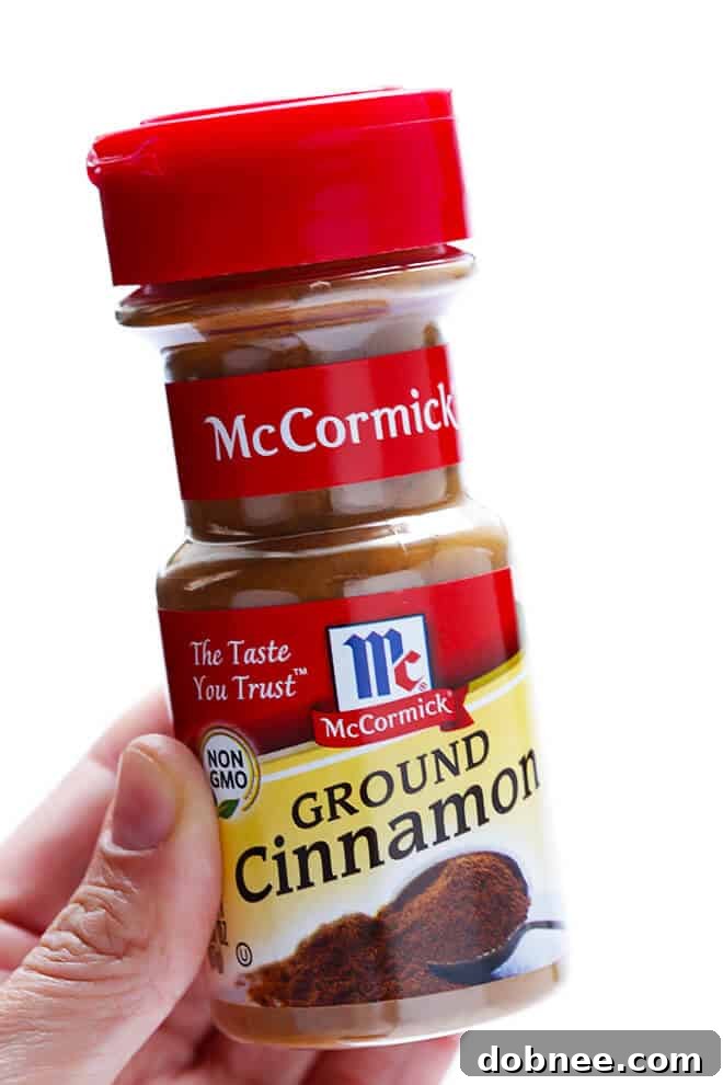 Preparing the cinnamon-spiced apple filling, the heart of this irresistible Slow Cooker Apple Crisp.