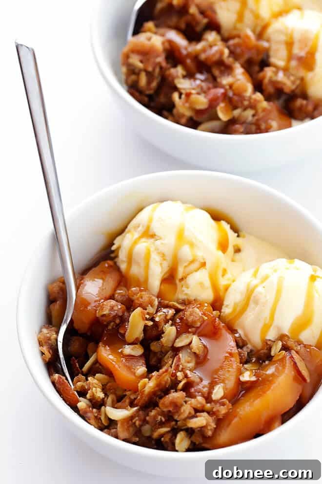 Slow Cooker Apple Crisp served with a scoop of vanilla ice cream and a drizzle of caramel sauce.