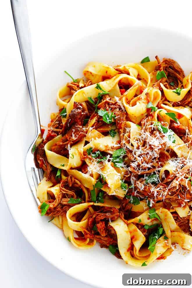 Close-up of Slow Cooker Beef Ragu simmering, showing the rich texture of the tomato sauce and tender beef.