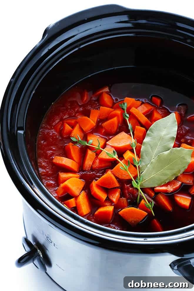 Fresh ingredients for Slow Cooker Beef Ragu: flank steak, garlic, tomatoes, and herbs, ready for the crock-pot.