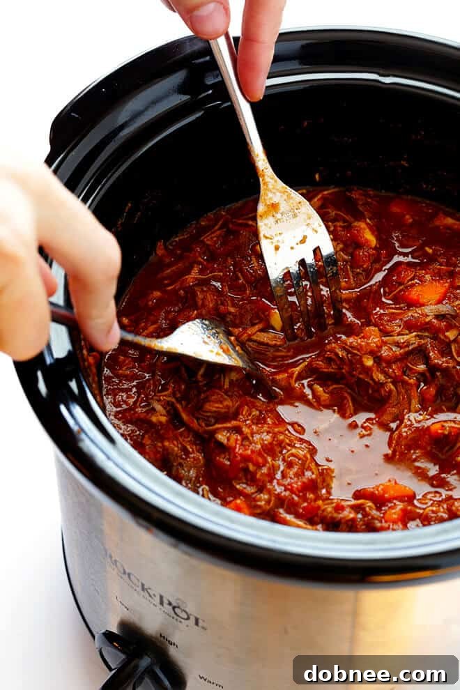 Shredded Slow Cooker Beef Ragu, tender and rich, ready to be mixed with pasta.
