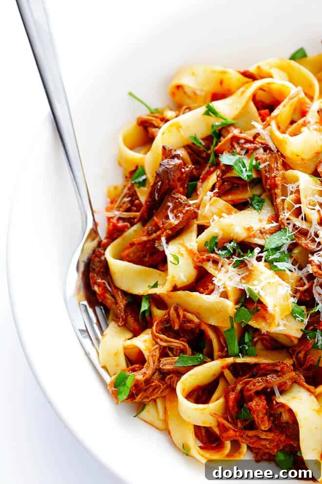 Close-up of a serving of Slow Cooker Beef Ragu with pappardelle, inviting you to enjoy this comforting dish.