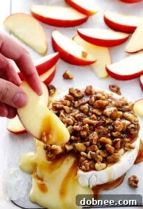 A delicious Caramel Apple Baked Brie with fresh apple slices.
