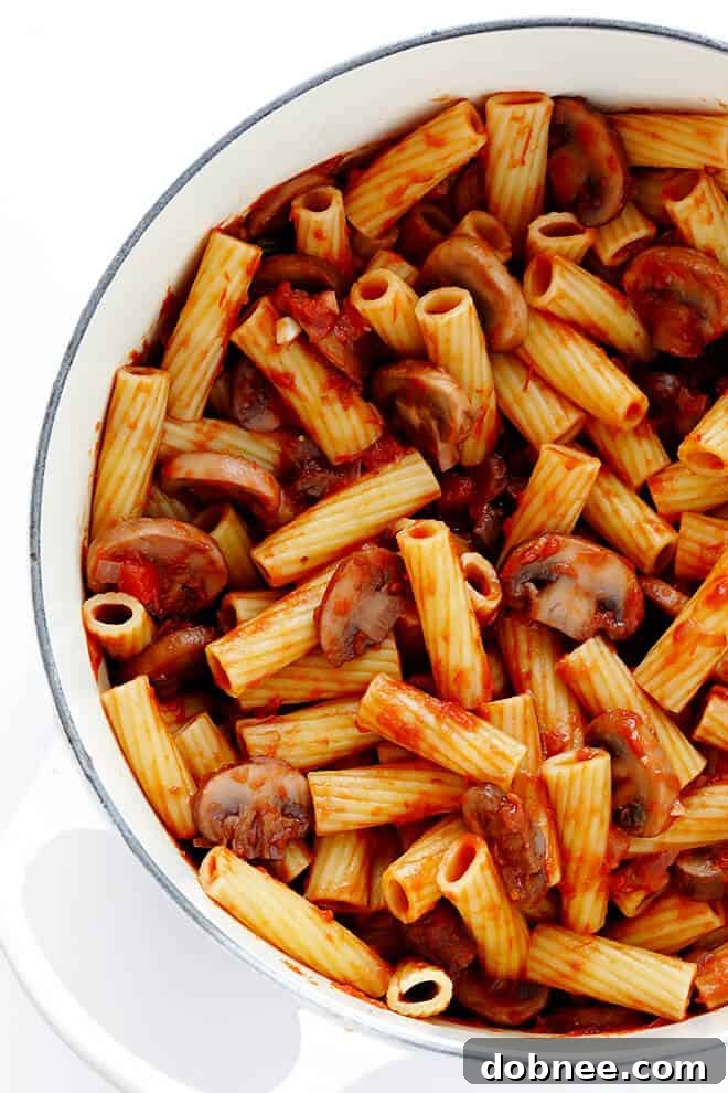Close-up of Rigatoni with Mushrooms, Rosemary and Parmesan, highlighting the rich sauce and fresh ingredients.