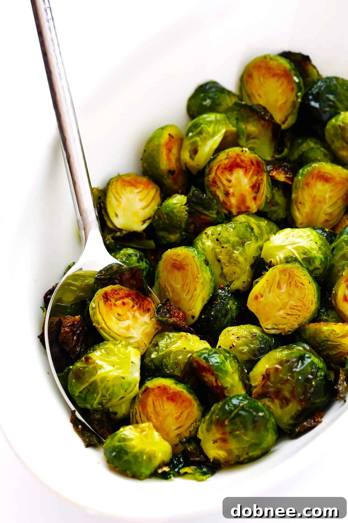 The BEST Roasted Brussels Sprouts Recipe - A vibrant plate of perfectly golden-brown, crispy Brussels sprouts, seasoned to perfection.