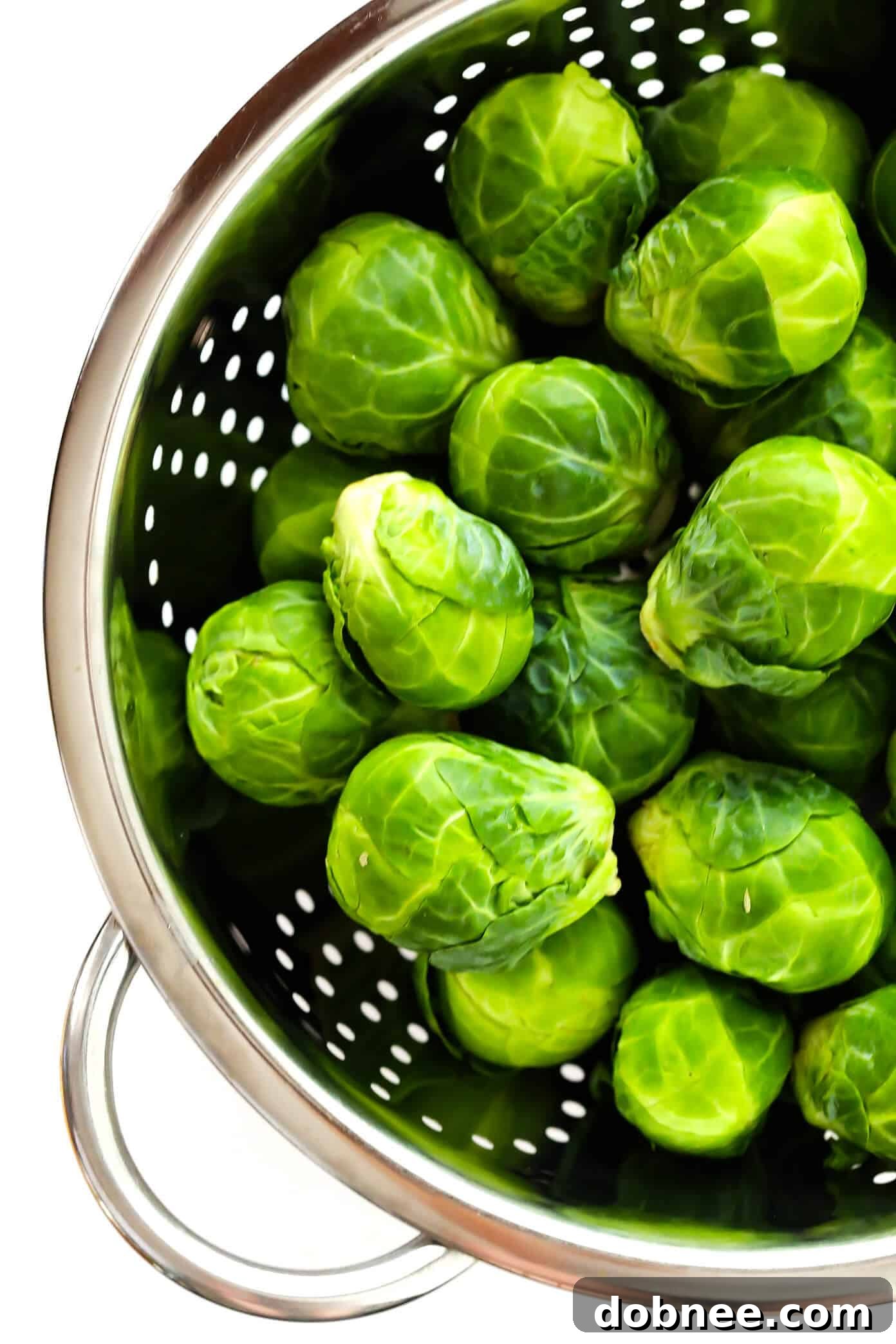 Raw Brussels Sprouts arranged on a cutting board, ready for preparation for the roasted Brussels sprouts recipe.