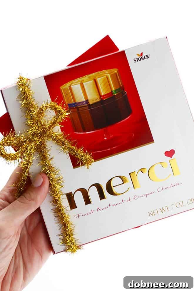 A festive Thanksgiving scene with a touch of elegance, featuring a sponsored message from merci chocolates.