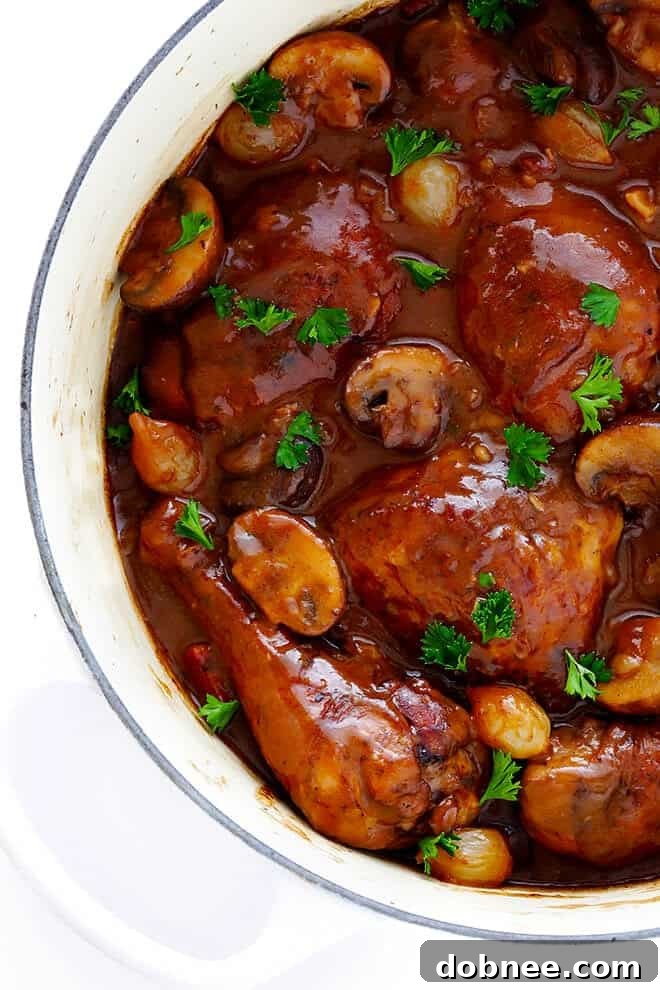 This classic Coq Au Vin recipe is surprisingly easy to make, and slow simmered in the most delicious French red wine sauce.