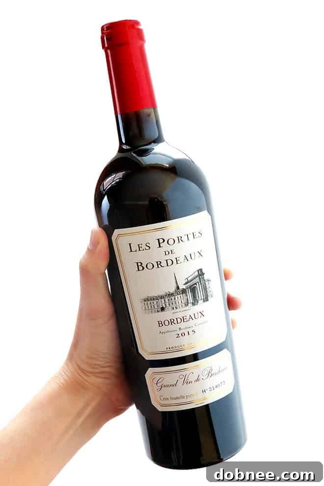 This classic Coq Au Vin recipe is surprisingly easy to make, and slow simmered in the most delicious French red wine sauce.