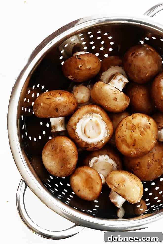 This classic Coq Au Vin recipe is surprisingly easy to make, and slow simmered in the most delicious French red wine sauce.