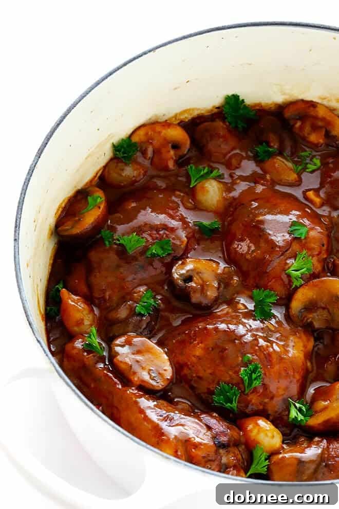 This classic Coq Au Vin recipe is surprisingly easy to make, and slow simmered in the most delicious French red wine sauce.