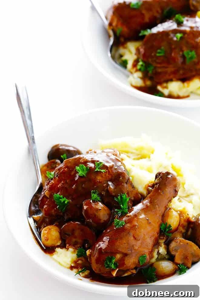 This classic Coq Au Vin recipe is surprisingly easy to make, and slow simmered in the most delicious French red wine sauce.