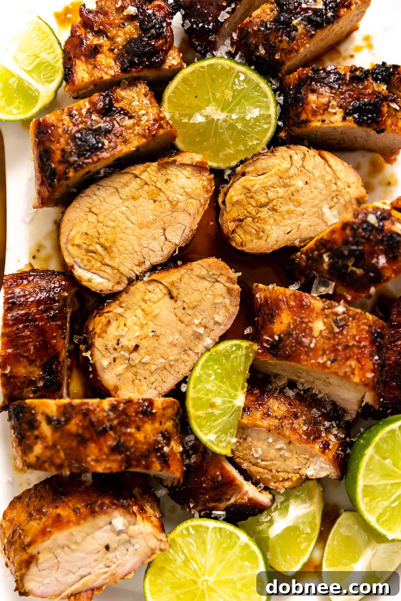 Zesty Ginger-Lime Pork Tenderloin 2 Perfectly grilled ginger lime pork tenderloin with a golden char, ready to be sliced and served