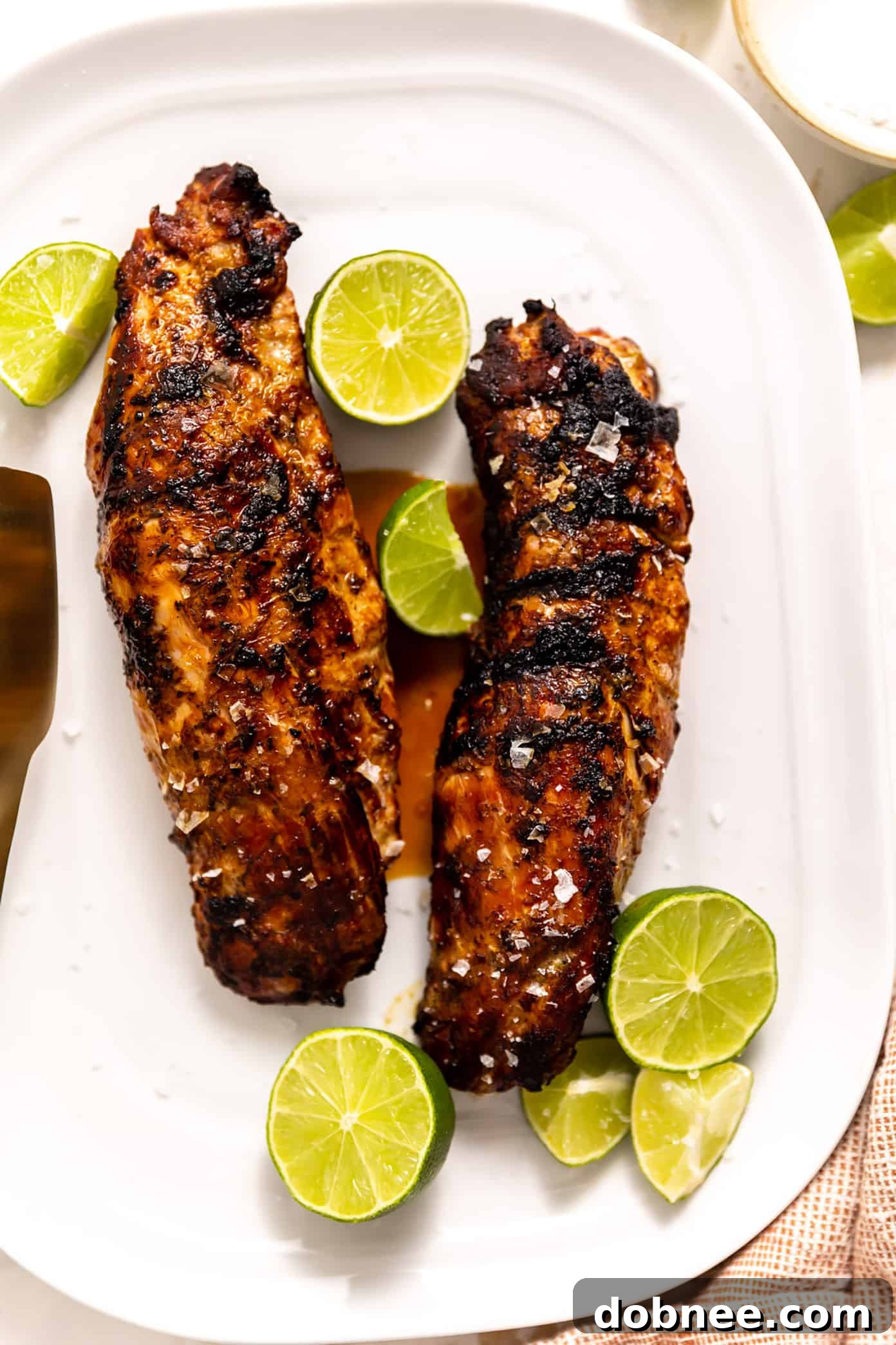 Zesty Ginger-Lime Pork Tenderloin 4 Close-up of fresh ginger and lime, key ingredients for the marinade, alongside pork tenderloin