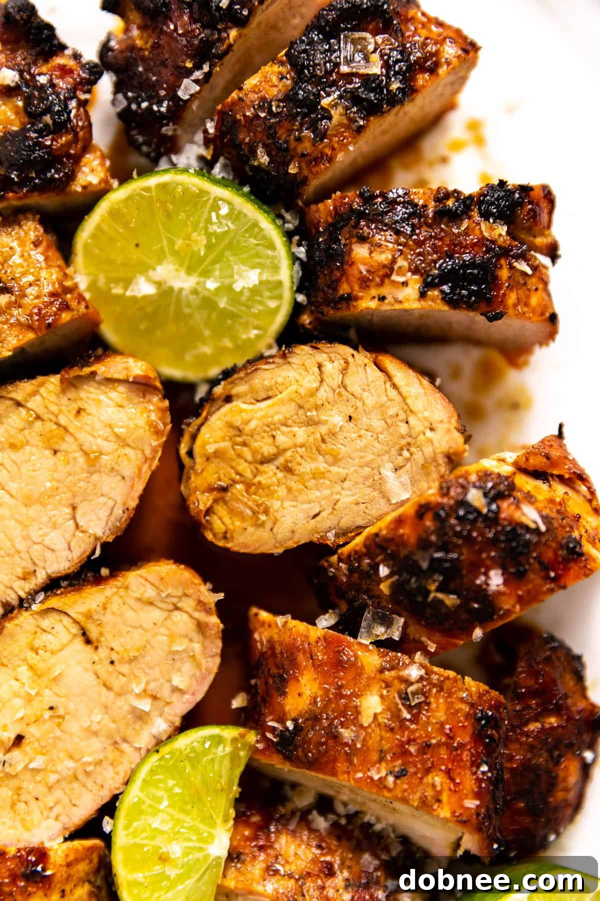 Zesty Ginger-Lime Pork Tenderloin 5 A perfectly cooked ginger lime pork tenderloin resting on a cutting board, ready to be sliced