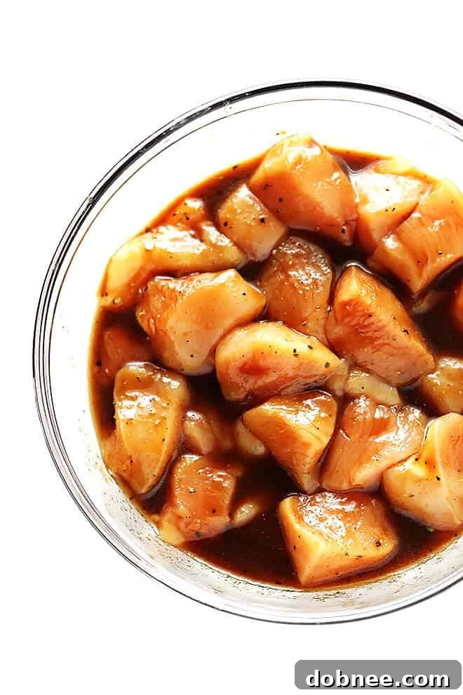 Close-up of a perfectly roasted Sheet Pan Chicken and Veggies Stir Fry, featuring crispy edges on broccoli, Brussels sprouts, and bell peppers, alongside succulent chicken pieces.