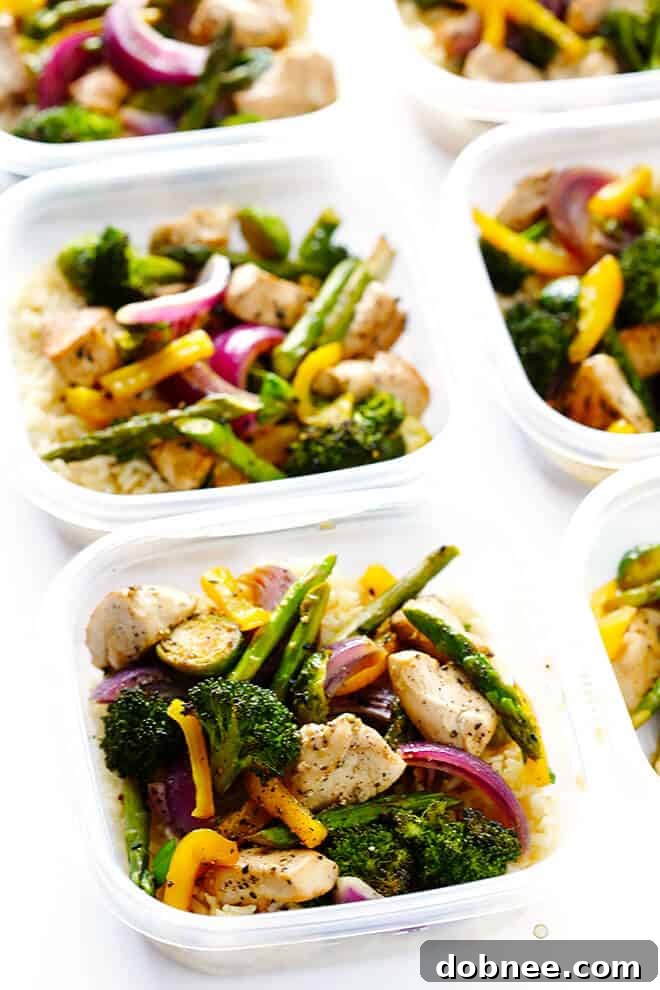 Individual meal prep containers filled with Sheet Pan Chicken and Veggies Stir Fry and brown rice, showcasing a healthy and convenient meal solution for the week.